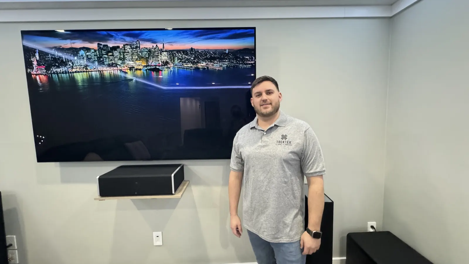 Paul from TrekTek in front of a finished TV wall